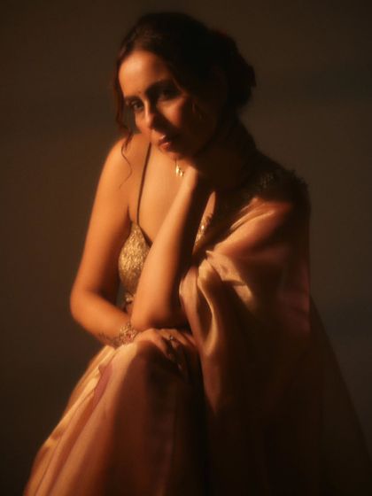 This frame captures a moment of quiet introspection. The lighting is soft and directional, sculpting her features and creating an intimate, painterly quality perfect for a fine art portrait.