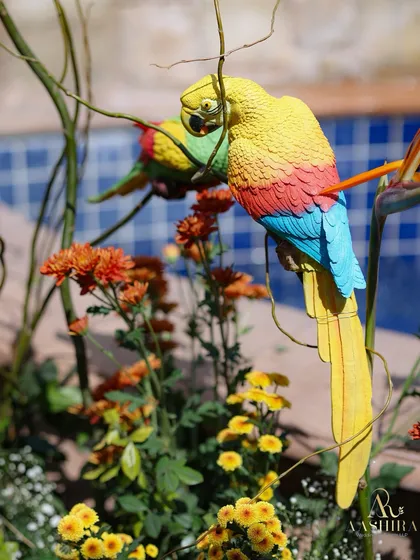 Another shot of the playful parrot decor, adding a touch of tropical fun to the floral arrangements.