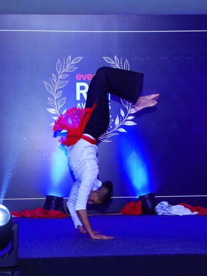 Our performances often include acrobatic and athletic elements. Here, one of our dancers executes a difficult handstand, demonstrating the high level of skill and physical control we bring to every show.