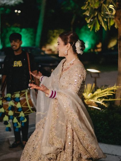 The bride enjoying her wedding festivities, with her floral bun staying perfectly in place.