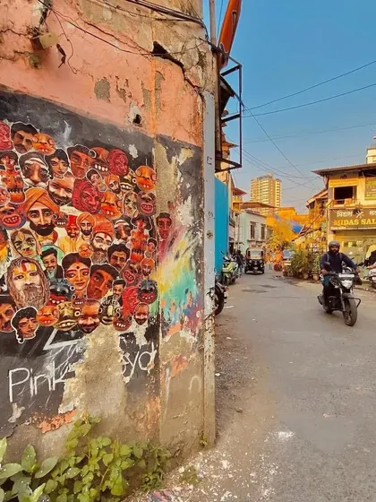 A wider view of the Chapel Road paste-up wall, showing its location on a typical Bandra street corner. It highlights how street art can activate and add character to underutilized spaces.