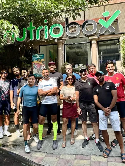 The team posing outside Nutriobox, our go-to spot for a healthy post-ride meal.