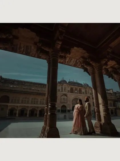 Using the pillars of a palace courtyard to frame the couple against the sky. This low-angle shot adds a sense of drama and magnificence.