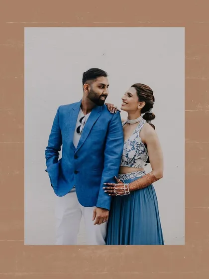A candid and happy portrait of a couple at their carnival-themed pre-wedding party.