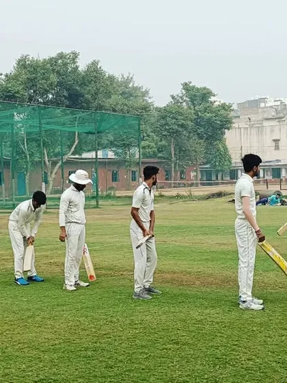 Players lining up for a batting drill, focusing on stance and backlift. Discipline and uniformity are key to our coaching.