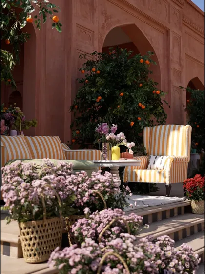 A cozy lounge nook from the "Art Day Out" brunch. The yellow and white striped chairs, set against the terracotta walls and orange trees, created a vibrant, Mediterranean feel.