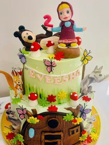 Into the whimsical world of Masha and the Bear for a 2nd birthday. This detailed two-tier cake is filled with handcrafted fondant characters and forest elements.