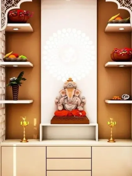 We designed this pooja unit with arched shelves and intricate side jali panels in a light wood finish. The layout provides ample open storage for offerings and decor, creating a functional and beautiful worship space.