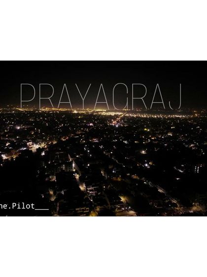 My city, Prayagraj, glowing in the dark. A simple aerial shot showing the city lights stretching out to the horizon.