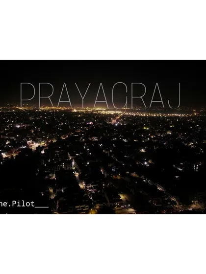 My city, Prayagraj, glowing in the dark. A simple aerial shot showing the city lights stretching out to the horizon.