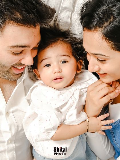 An intimate, top-down view of a family sharing a quiet moment. This unique angle creates a feeling of being enveloped in love.
