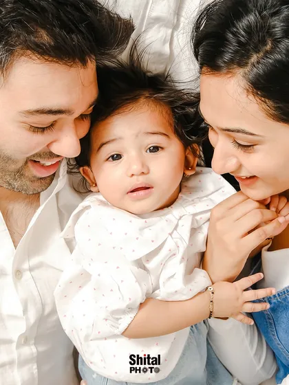 An intimate, top-down view of a family sharing a quiet moment. This unique angle creates a feeling of being enveloped in love.