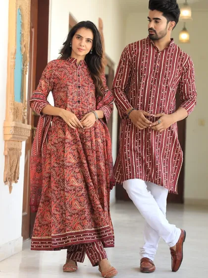 A striking red and indigo couple's set with a mix of paisley and striped prints. The Anarkali features a collared neck for a touch of sophistication.