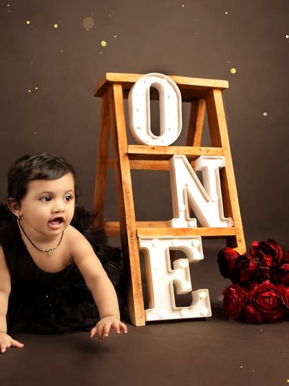 A candid shot of the birthday girl crawling, capturing her movement and curiosity during the session.