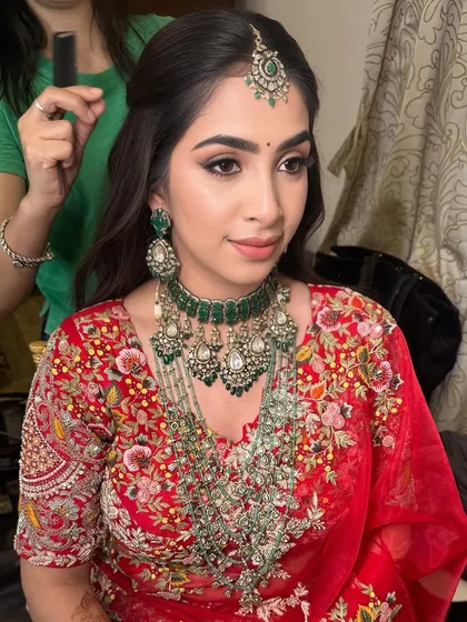 Another angle of this stunning reception style, showing the half-up hairstyle that perfectly complements the intricate jewelry and makeup.