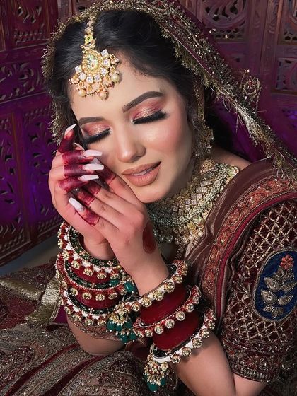 Another angle of this beautiful bride, with her eyes closed to showcase the stunning pink and gold glitter eyeshadow.