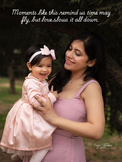 Time may fly, but love slows it all down. A mother and her one-year-old daughter share a sweet, happy moment during an outdoor milestone photoshoot.