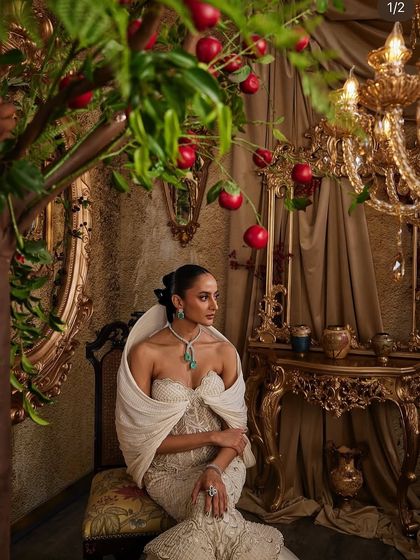 An ivory gown that celebrates contrast, with a corseted bodice that sculpts and a dramatic hooded panel that adds quiet power.