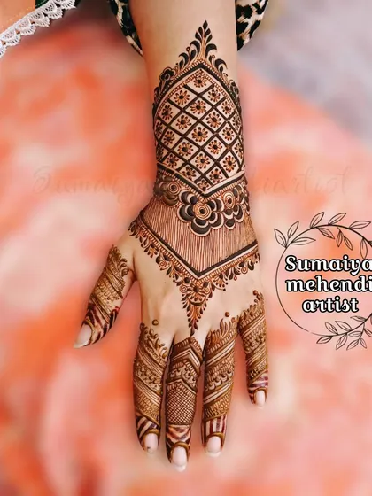 A party henna design with a beautiful cuff pattern and detailed work on the fingers.