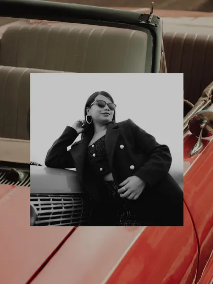 A stylish, artistic shot focusing on the bride-to-be during a vintage car shoot. The creative framing and editing give this portrait a unique, high-fashion feel.
