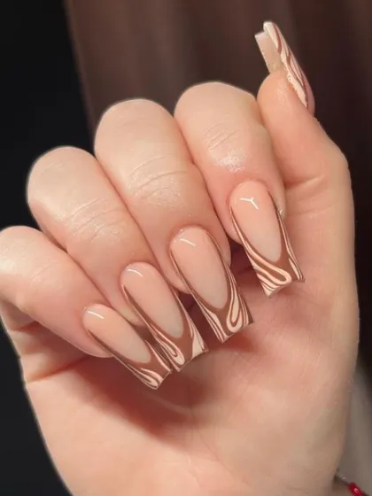 A trendy "latte swirl" design with shades of brown on long square nails.