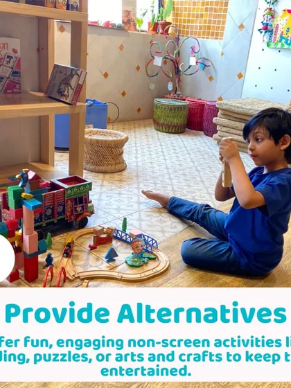 A boy building an elaborate train track. Providing engaging, non-screen alternatives like this is key to promoting creativity and independent thinking.