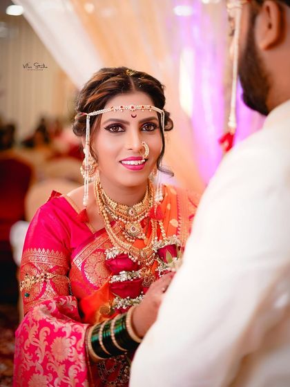 An over-the-shoulder view of the bride looking at her groom. Her expression is full of love and happiness, a perfect candid capture from the ceremony.