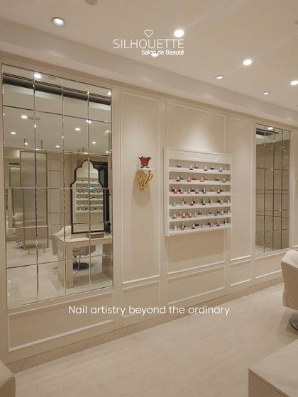 A view of our nail artistry section, featuring a curated display of polishes against our elegant, panelled walls. Every corner of our salon is designed to provide a transformative and relaxing beauty experience.