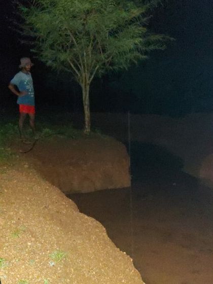 The excavated pit, now filled with rainwater. This demonstrates our holistic approach to site management, where the process of sourcing building materials also creates a valuable resource for the farm.