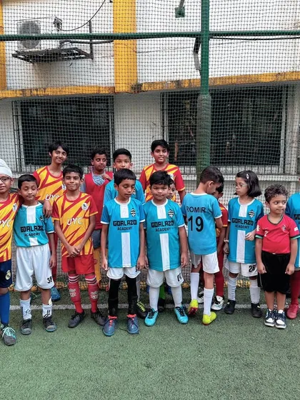 Players from both teams line up before a friendly match, a great display of sportsmanship.