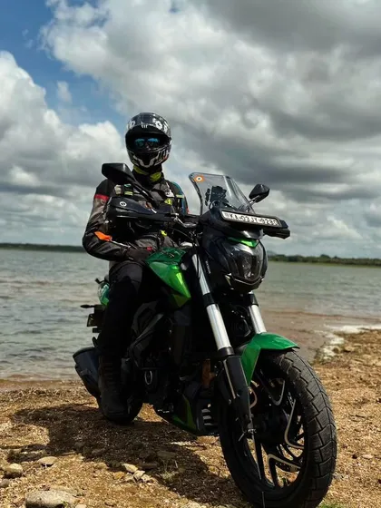 Taking a moment of travel therapy with our Dominar 400 by a serene lake. Our rides are the perfect escape, blending the thrill of the road with the peace of nature.