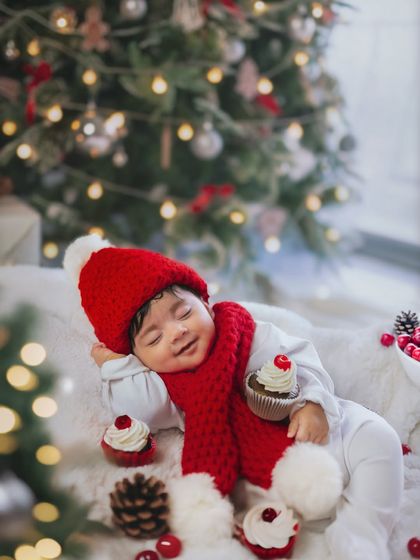 A very merry first Christmas. This little one is sleeping soundly during his two-month milestone shoot, complete with a Santa hat and festive details.
