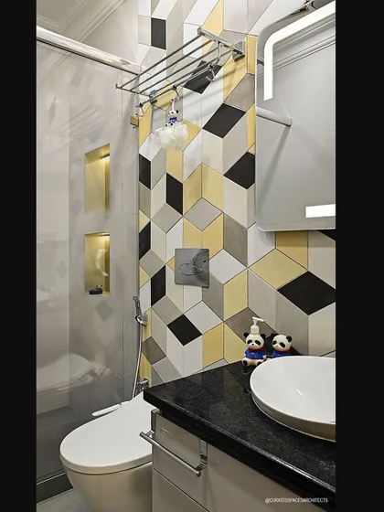 Even a kid's bathroom can be stylish. I used playful 3D geometric tiles in yellow, black, and white to create a fun and energetic feature wall in this bathroom.