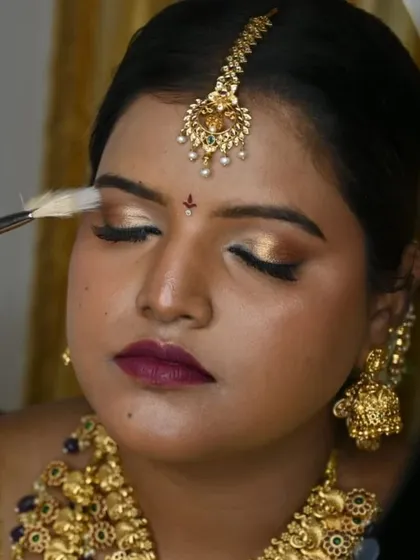A close-up on the artistry. This shot highlights the shimmering gold eyeshadow and flawless blending, a key part of creating a glamorous yet traditional bridal eye.