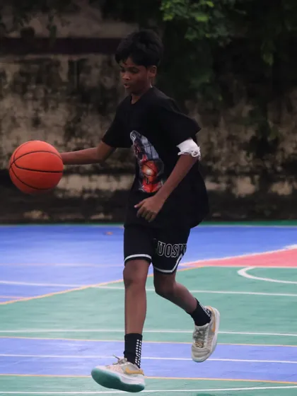 A young player dribbles confidently. We provide the training and community to help next-gen hoopers succeed.