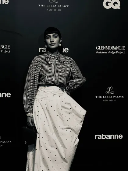 A black and white shot from the GQ event, giving the classic outfit a timeless feel.