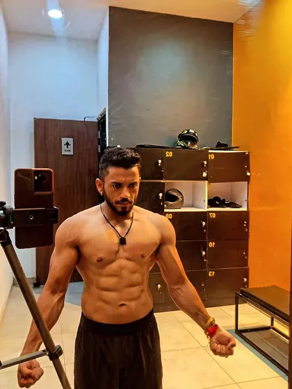 Another locker room shot showing a lean and conditioned physique. The work is done daily, not just for a photo.