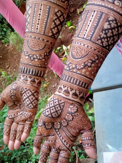 A similar bridal design seen from a different angle, emphasizing the density and richness of the patterns that cover the hands and arms completely.
