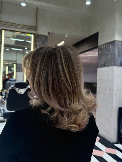 A side view of this cool blonde style. The highlights are blended perfectly, creating a natural yet striking look.