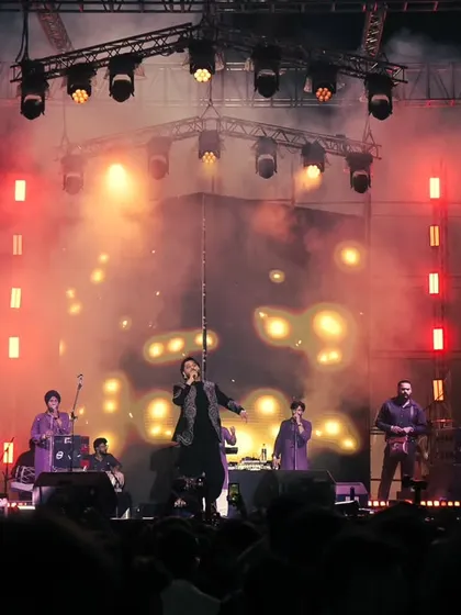 Performing on a grand stage with my band, with live visuals on the big screens. We aim to create a complete audio-visual spectacle for our audience.