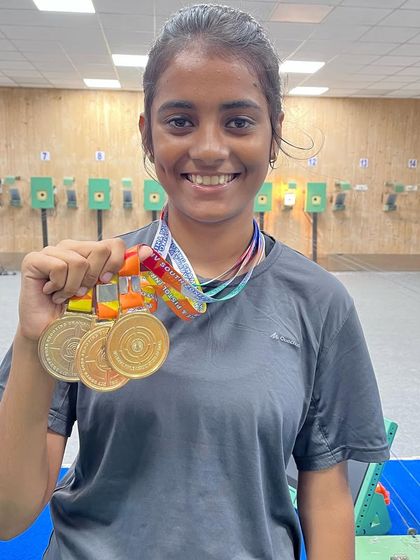 Supriya celebrating her victory of 3 Gold medals in the Junior, Youth, and Sub-Youth categories at the South Zone shooting competition in Trivandrum.