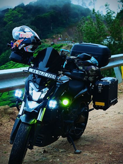 Our fully-loaded Dominar 400, equipped with panniers and auxiliary lights, during a ride through the misty hills of Munnar, Kerala. We also organize tours to the beautiful ghats of South India.