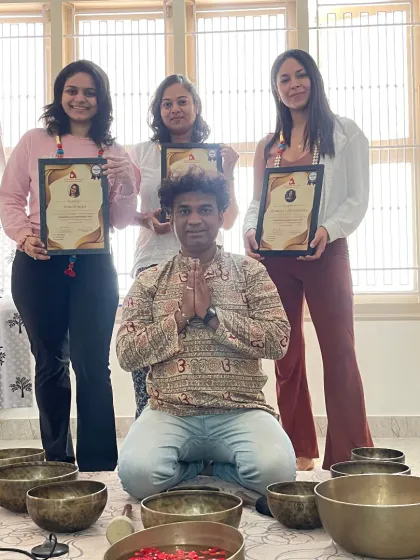 A group of newly certified sound healers, celebrating their accomplishment with joy and enthusiasm.