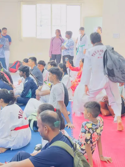 A view from the back of the hall during the state trials, showing the scale of participation and the supportive community.