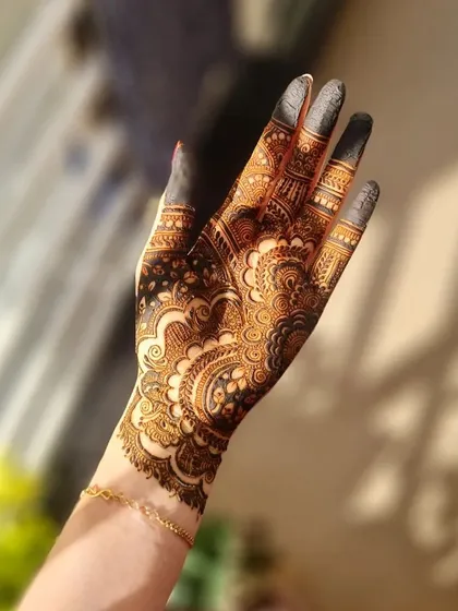 The rich, dark stain of a detailed and intricate design, glowing in the sunlight.