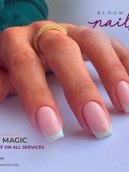 A modern French manicure with a soft mint green tip on a classic square-shaped nail.