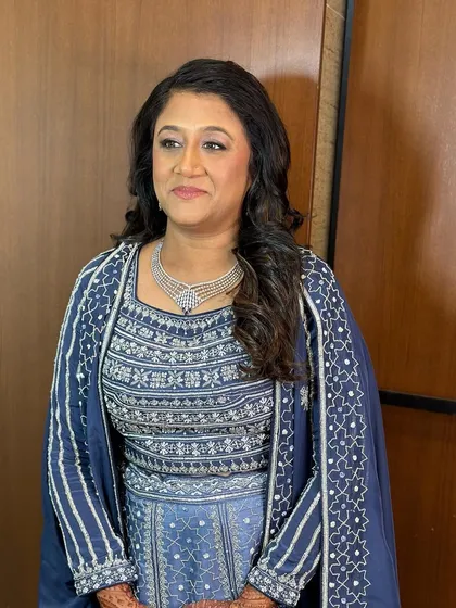 A beautiful portrait of the mother of the groom, looking elegant and ready for the sangeet with her softly waved hair.