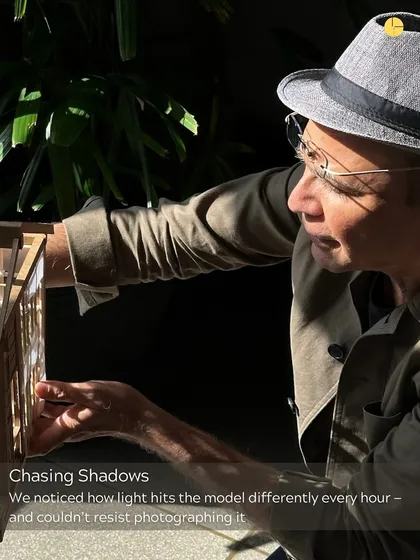 Chasing shadows. We are constantly observing how light interacts with our designs. Here, the principal architect studies a physical model, noticing how the light hits it differently at every hour of the day.