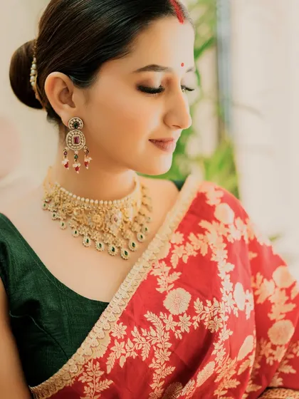A side profile showing the elegant bun and the details of the jewellery.