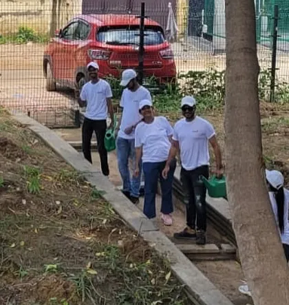 A team of 30 employees from Orbis Financial walks along a path at Aravali Creek, ready to plant 200 native saplings and contribute to the site's ecological health.